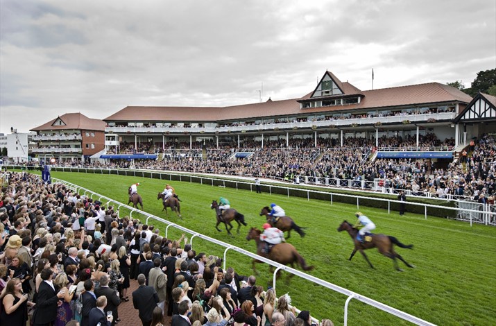 People from liverpool gather to watch thrilling horse races on the track, enjoying the vibrant atmosphere