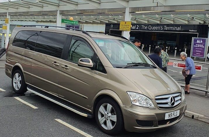 A Mercedes Benz minivan parked at the airport, perfect for booking a taxi to the airport for your travel needs